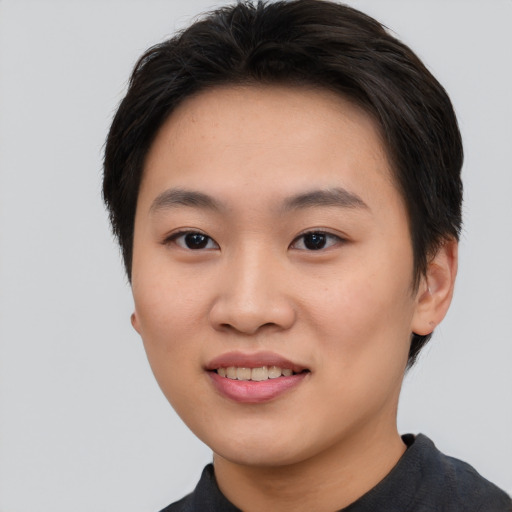 Joyful asian young-adult female with short  black hair and brown eyes