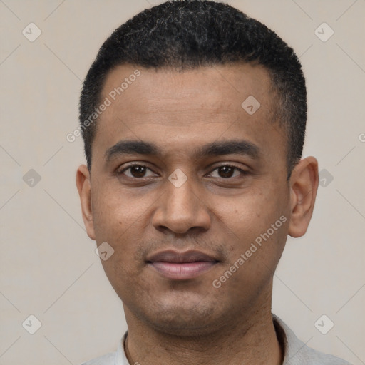 Joyful latino young-adult male with short  black hair and brown eyes