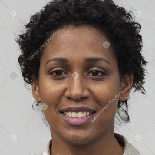 Joyful black adult female with short  brown hair and brown eyes