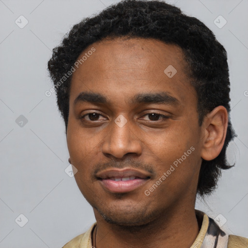 Joyful black young-adult male with short  black hair and brown eyes