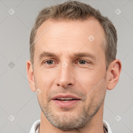 Joyful white adult male with short  brown hair and brown eyes