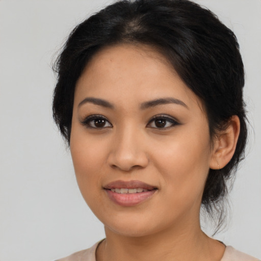 Joyful latino young-adult female with medium  brown hair and brown eyes