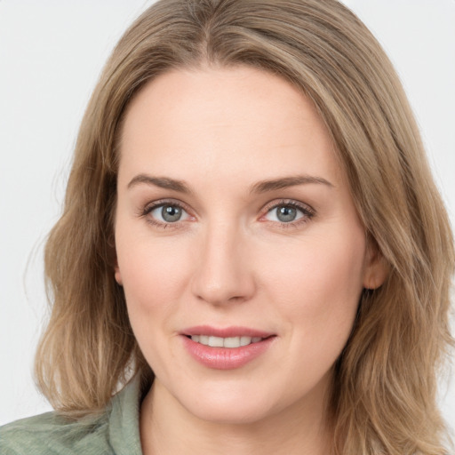 Joyful white young-adult female with medium  brown hair and green eyes