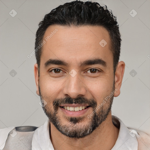 Joyful white young-adult male with short  black hair and brown eyes