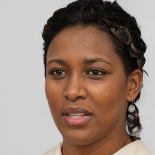 Joyful black young-adult female with medium  brown hair and brown eyes