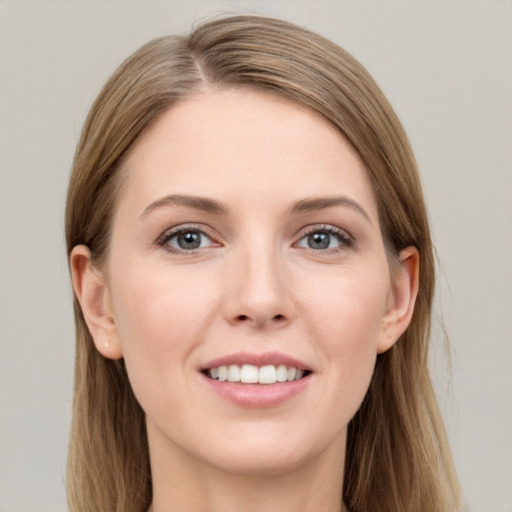 Joyful white young-adult female with long  brown hair and grey eyes