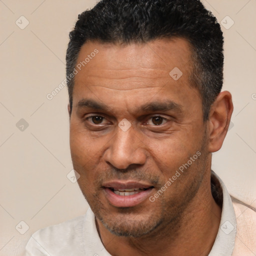Joyful white adult male with short  black hair and brown eyes