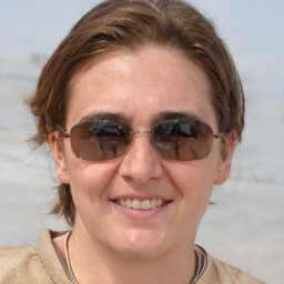 Joyful white adult female with medium  brown hair and blue eyes