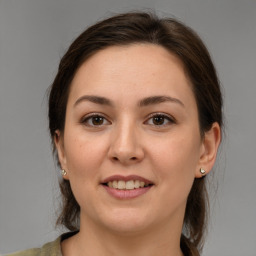 Joyful white young-adult female with medium  brown hair and brown eyes