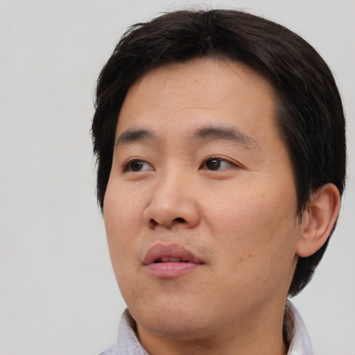 Neutral asian young-adult male with short  brown hair and brown eyes