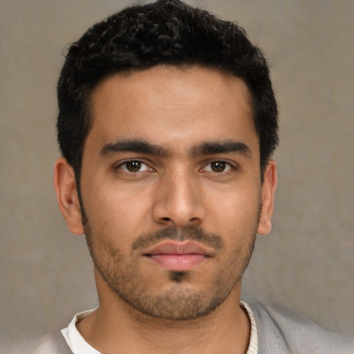 Neutral latino young-adult male with short  black hair and brown eyes