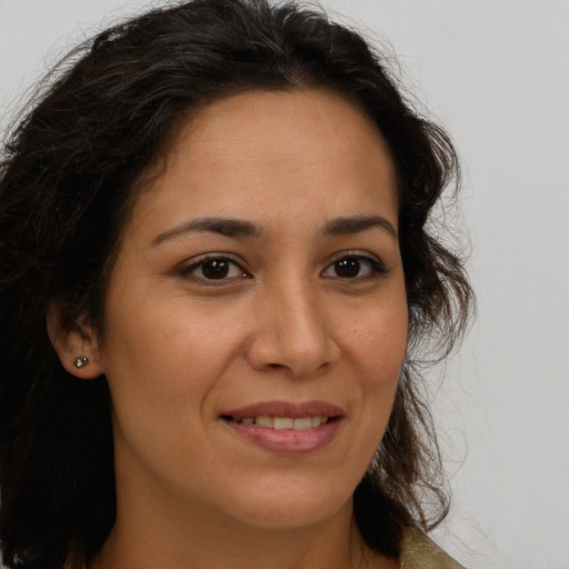 Joyful latino young-adult female with medium  brown hair and brown eyes