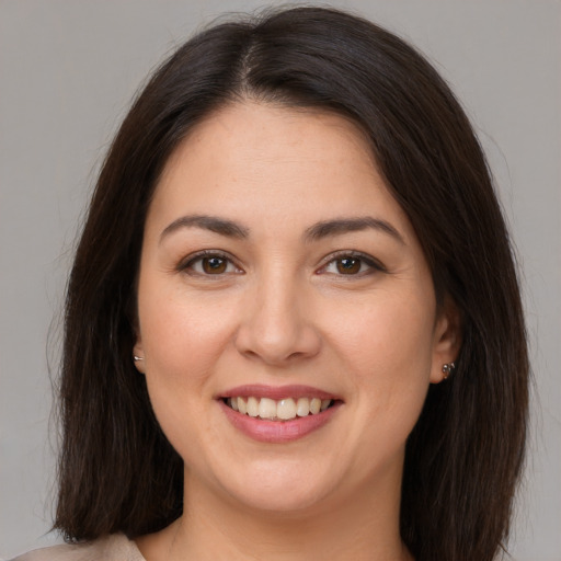 Joyful white young-adult female with medium  brown hair and brown eyes