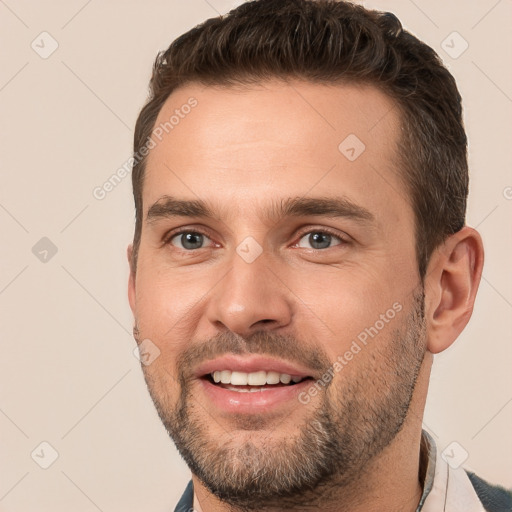 Joyful white young-adult male with short  brown hair and brown eyes