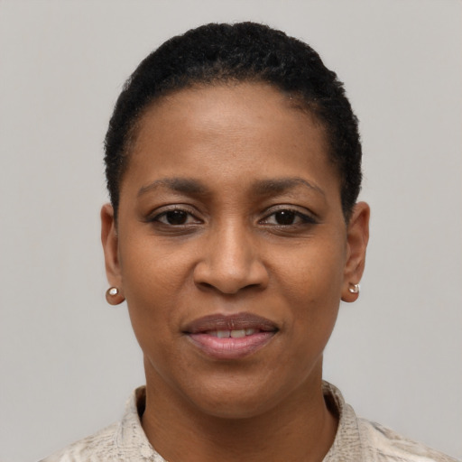 Joyful black young-adult female with short  black hair and brown eyes
