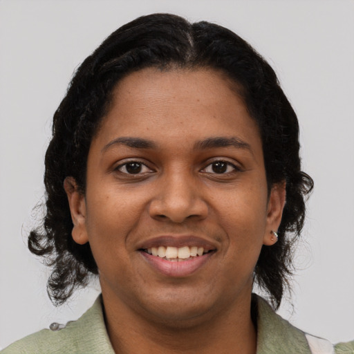 Joyful black young-adult female with medium  black hair and brown eyes