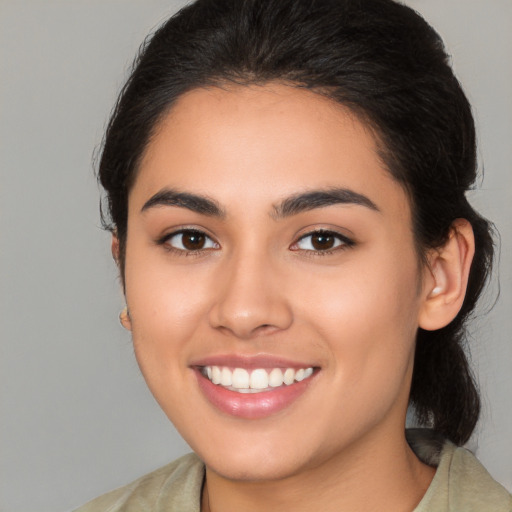 Joyful white young-adult female with medium  brown hair and brown eyes