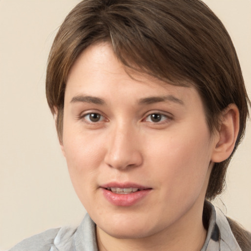 Joyful white young-adult female with medium  brown hair and brown eyes