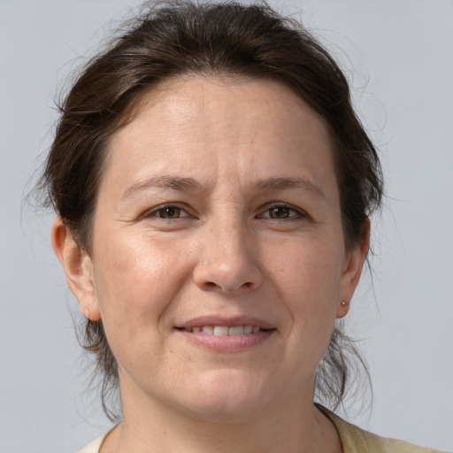 Joyful white adult female with medium  brown hair and brown eyes