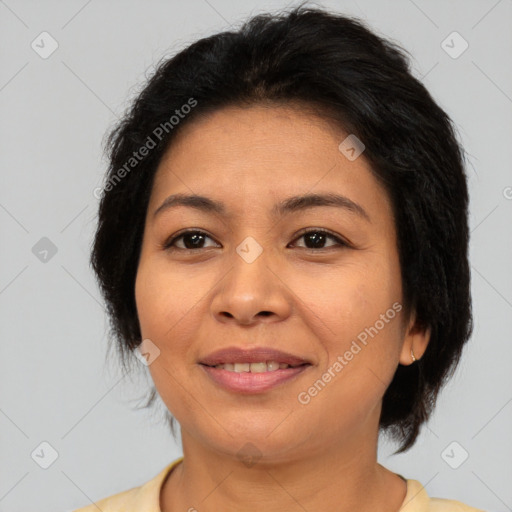 Joyful asian adult female with medium  brown hair and brown eyes