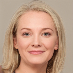 Joyful white adult female with long  brown hair and grey eyes