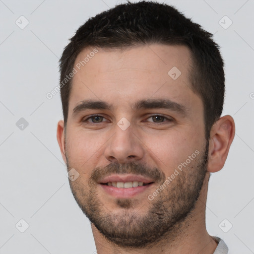 Joyful white young-adult male with short  brown hair and brown eyes