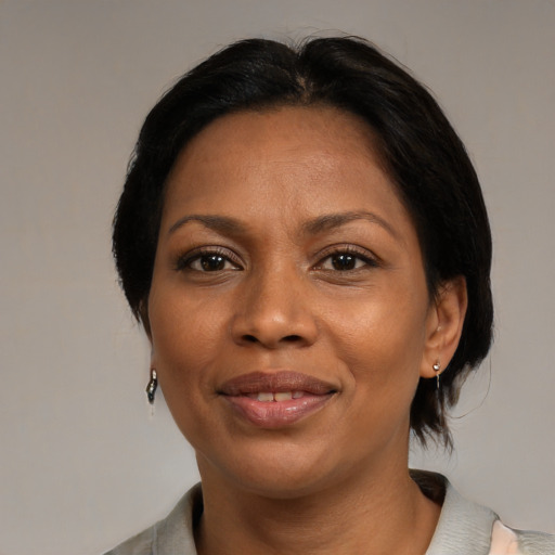 Joyful black adult female with medium  black hair and brown eyes