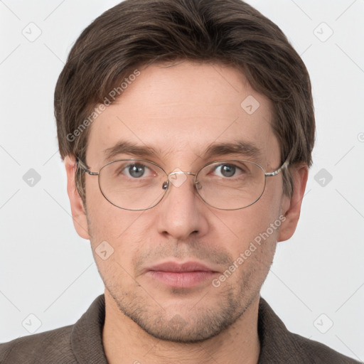 Joyful white adult male with short  brown hair and grey eyes