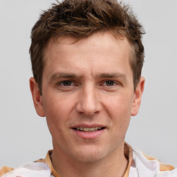 Joyful white adult male with short  brown hair and brown eyes