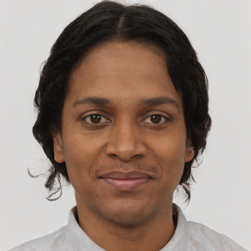 Joyful black adult female with short  brown hair and brown eyes