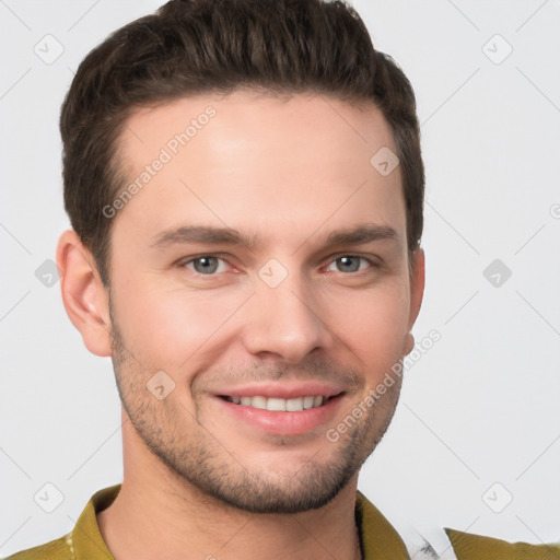 Joyful white young-adult male with short  brown hair and grey eyes