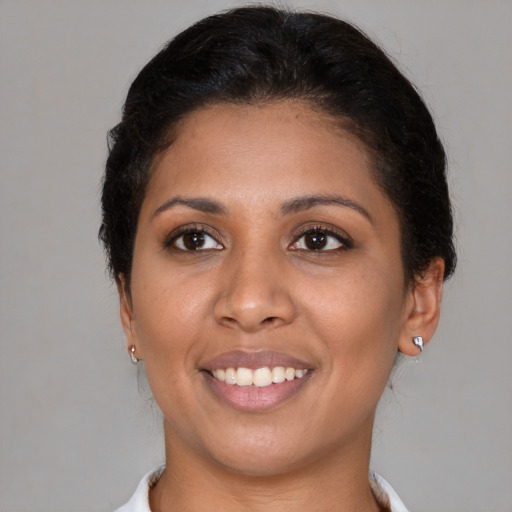 Joyful black young-adult female with short  brown hair and brown eyes