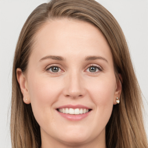 Joyful white young-adult female with long  brown hair and grey eyes