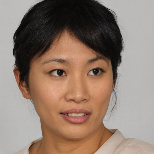 Joyful asian young-adult female with medium  brown hair and brown eyes