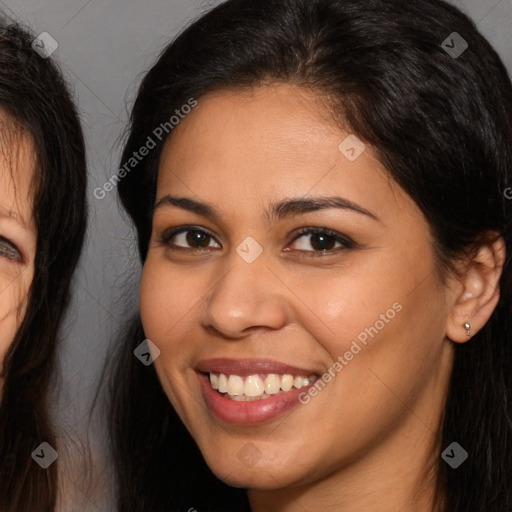 Joyful latino young-adult female with long  brown hair and brown eyes