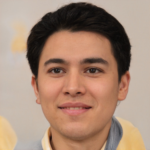 Joyful white young-adult male with short  black hair and brown eyes