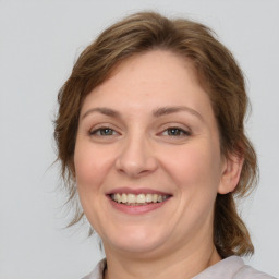 Joyful white young-adult female with medium  brown hair and brown eyes