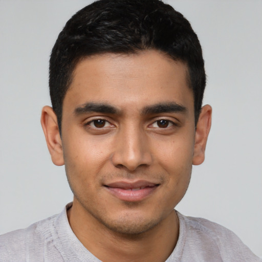 Joyful latino young-adult male with short  black hair and brown eyes