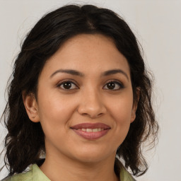 Joyful latino young-adult female with medium  brown hair and brown eyes