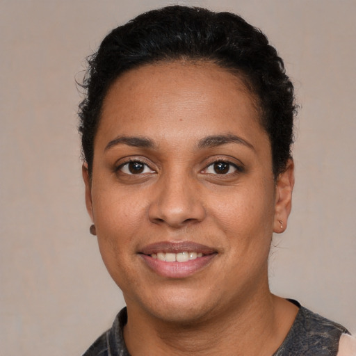 Joyful latino young-adult female with short  black hair and brown eyes