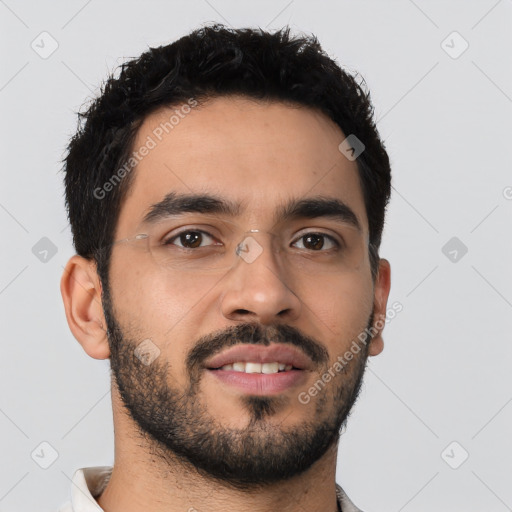 Joyful latino young-adult male with short  black hair and brown eyes