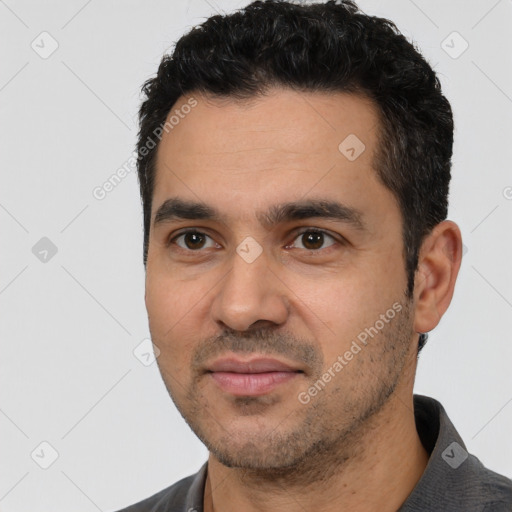 Joyful white young-adult male with short  black hair and brown eyes