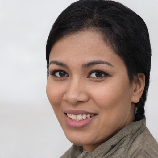 Joyful latino young-adult female with short  brown hair and brown eyes
