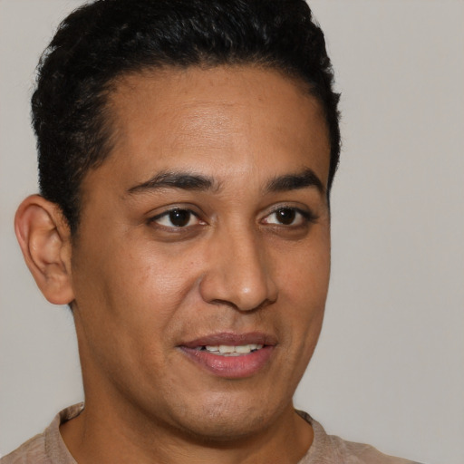 Joyful latino young-adult male with short  brown hair and brown eyes