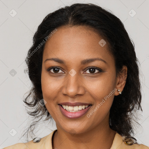 Joyful black young-adult female with long  brown hair and brown eyes