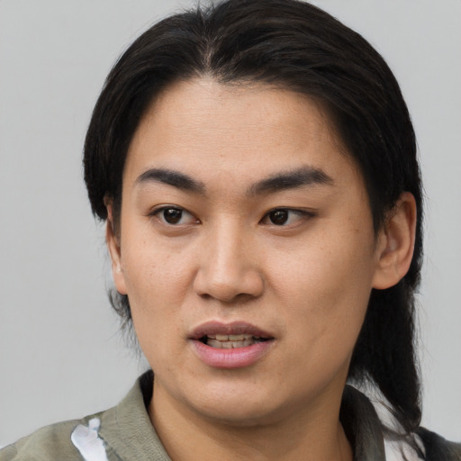Joyful asian young-adult female with medium  black hair and brown eyes