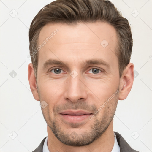 Joyful white adult male with short  brown hair and brown eyes