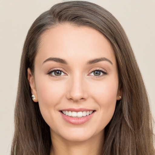 Joyful white young-adult female with long  brown hair and brown eyes