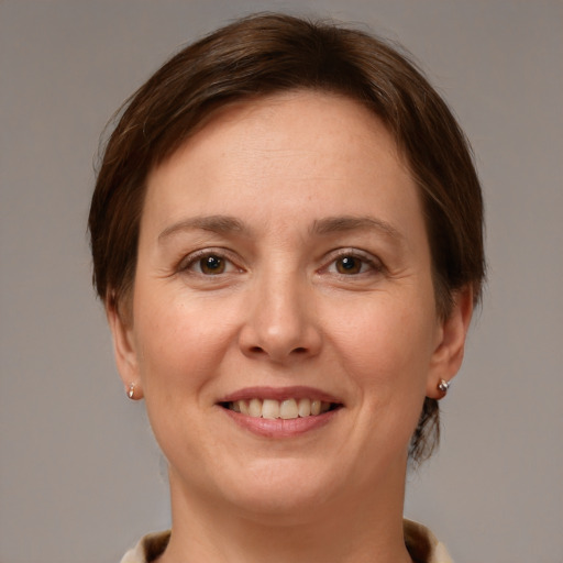 Joyful white young-adult female with short  brown hair and grey eyes