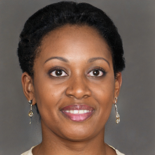Joyful black adult female with short  brown hair and brown eyes